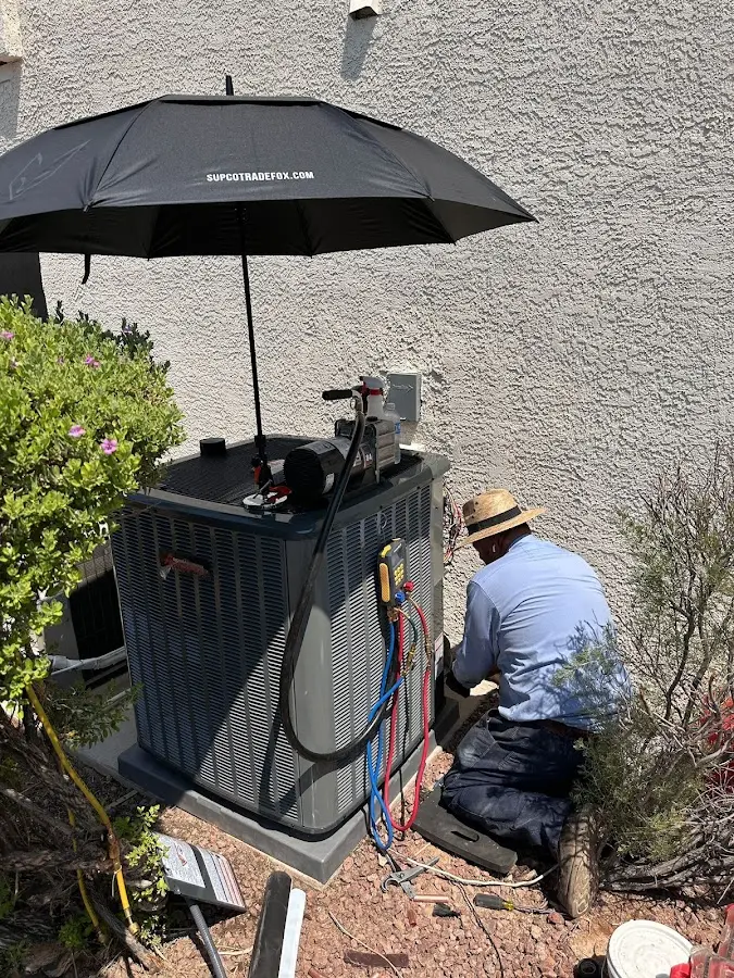 HVAC technician performing outdoor AC maintenance in Westfield